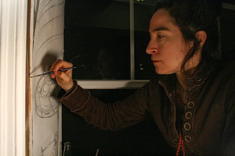 Maura Holden painting Mushroom Cafe mural